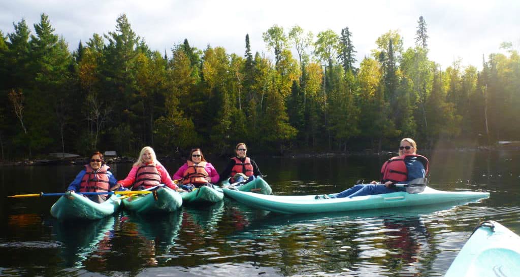 Women kayaking in BWCAW with Canyon Calling Adventures