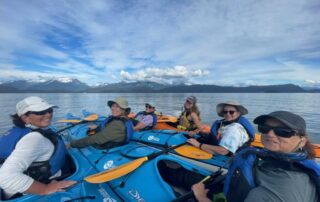 Women having a great time kayaking through the channels of Alaska