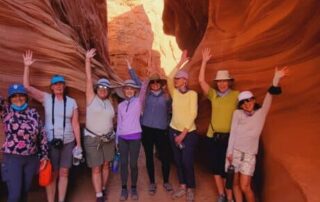Women hiking through the gorgeous red canyons of the southwest with Canyon Calling