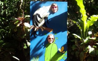 Women getting pictures with a peep board in Costa Rica
