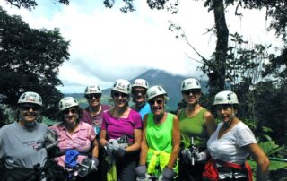 Women ziplining together in small groups in Costa Rica with Canyon Calling Adventures