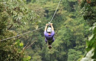 Woman ziplining over the Costa Rica jungle - Active trips with Canyon Calling