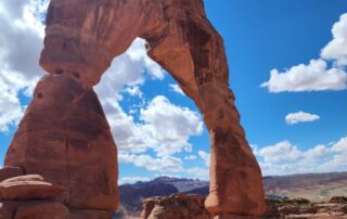 Women walking beneath Utah's Delicate Arch