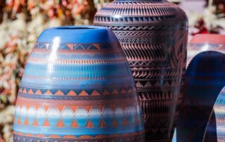 Southwestern pottery in a shop in Santa Fe New Mexico with chilies hanging on the background