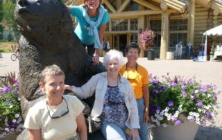 Women posing with a bear statue in Idaho