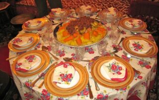 Bountiful Moroccan dish atop floral tablecloth