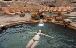 Woman relaxing in the pool of a hotel in Northern New Mexico