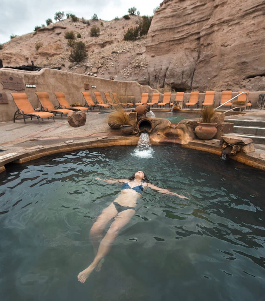 Woman relaxing in the pool of a hotel in Northern New Mexico