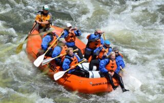 Women white water rafting the Payette River - Hold on tight!