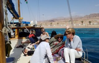 Women relaxing on Red Sea boat ride - Jordan small group adventures with Canyon Calling