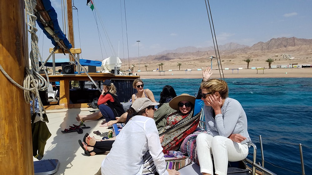 Women relaxing on Red Sea boat ride - Jordan small group adventures with Canyon Calling