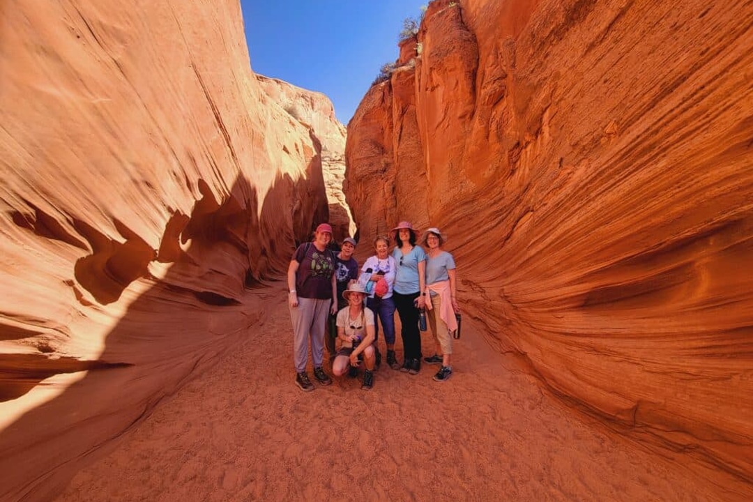 Women hiking the Wupatki National Monument on a vacation with Canyon Calling to AZ