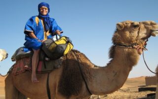 Woman riding a camel in Morocco