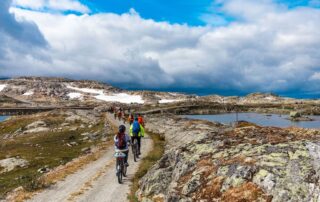 Women biking through the wondrous Norwegian landscape