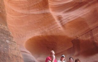 Women hiking together in small groups in the red canyons of AZ