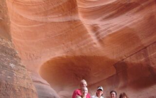 Women hiking together in small groups in the red canyons of AZ