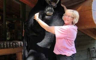 Woman posing with giant stuffed bear in Canada