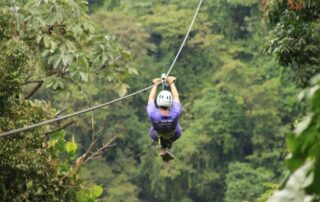 Woman ziplining over the Costa Rica jungle - Active trips with your tribe and Canyon Calling