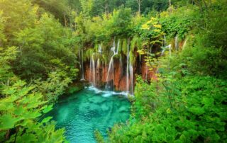 Bask in the travertine waterfalls of Plitvice National Park in Plitvice, Croatia