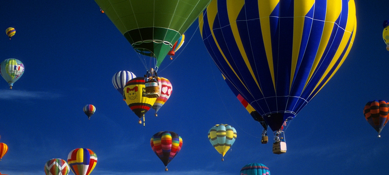 Hot air balloons lifting skyward at Albuquerque International Balloon Fiesta, NM - women-only trips with Canyon Calling