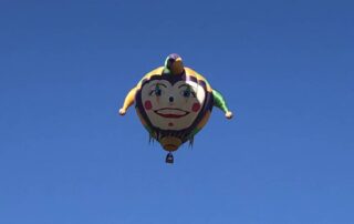 Jester hot-air balloon floating alone in the sky - Canyon Calling small group getaways for women-only