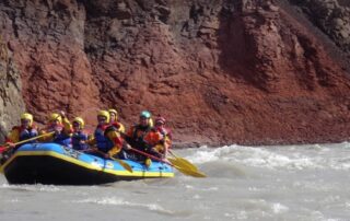 Women white water rafting together in small groups in Iceland