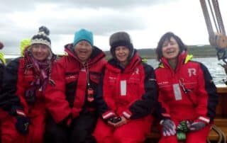 Women having a great time boating to see icebergs in Iceland