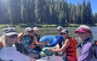 Women having fun rafting the turbulent waters of Idaho with Canyon Calling