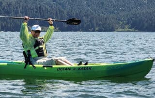 Woman kayaking the Big Lagoon on the Redwood Coast - Northern California active adventures for women-only