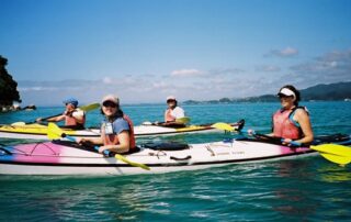 Women sea kayaking together in small groups in Abel Tasman National Park - New Zealand private tours with Canyon Calling