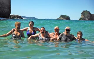 Women having a blast swimming in the turquoise waters of New Zealand