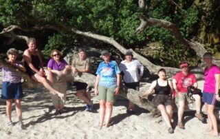 Small tribe of women exploring the golden sand beaches of New Zealand