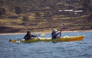 Women kayaking together in small groups on Lake Titicaca, Peru