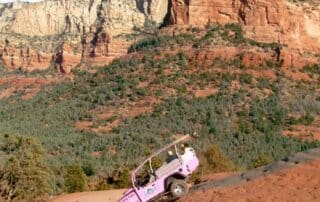 Pink jeep scaling the mountains of Sedona, Arizona - Women adventure getaways to the southwest