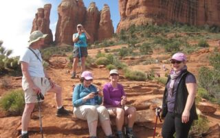 Women trekking through Sedona's red rocks with Canyon Calling Adventure Tours