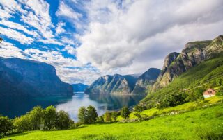 Scenic view of vibrant green and blue fjord in Norway - Women Travel Adventure Getaways