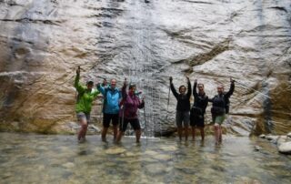 Women having a great time hiking through shallow water in one of Utah's beautiful canyons
