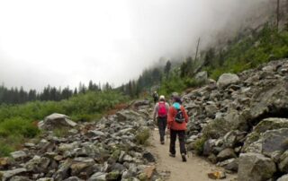 Small group of women hiking the misty landscapes of Yellowstone