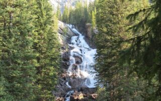 Travelling adventures for women to Yellowstone National Park: Explore cascading waterfalls and magical rocky landscapes.