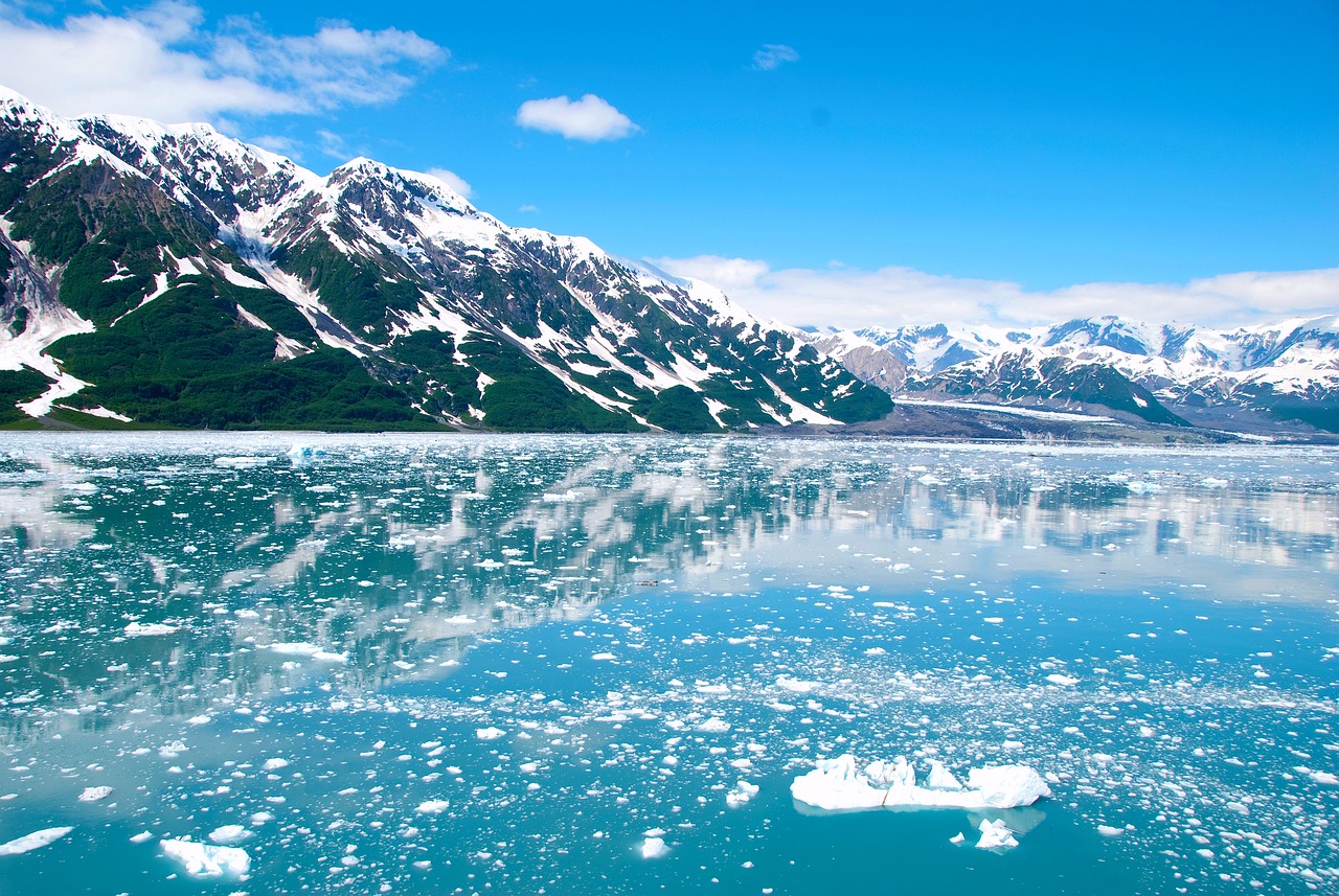 Alaska tour landscape featuring crystal clear waters and snow-capped mountains.